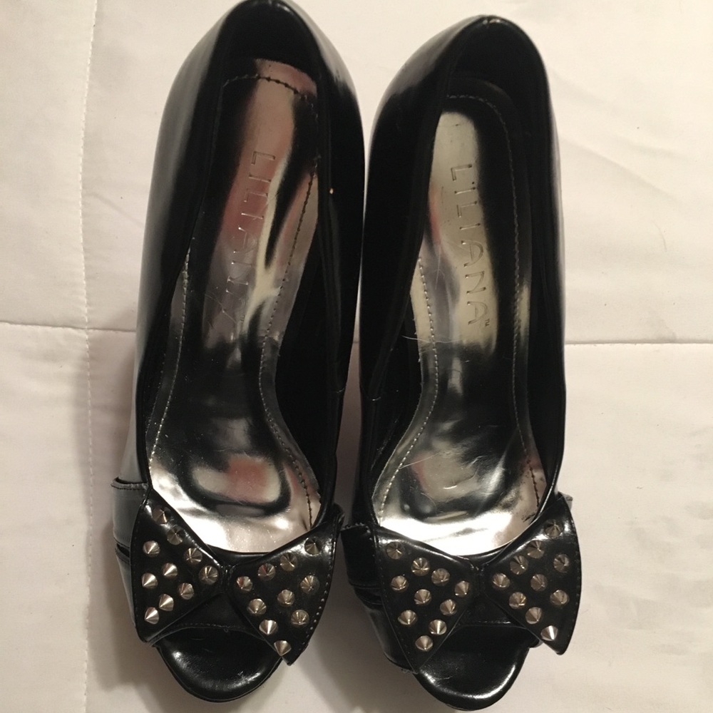 Black peep toe platform heels with studded bows.
